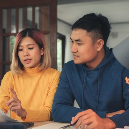 young-asian-couple-managing-finances-reviewing-their-bank-accounts-using-laptop-computer